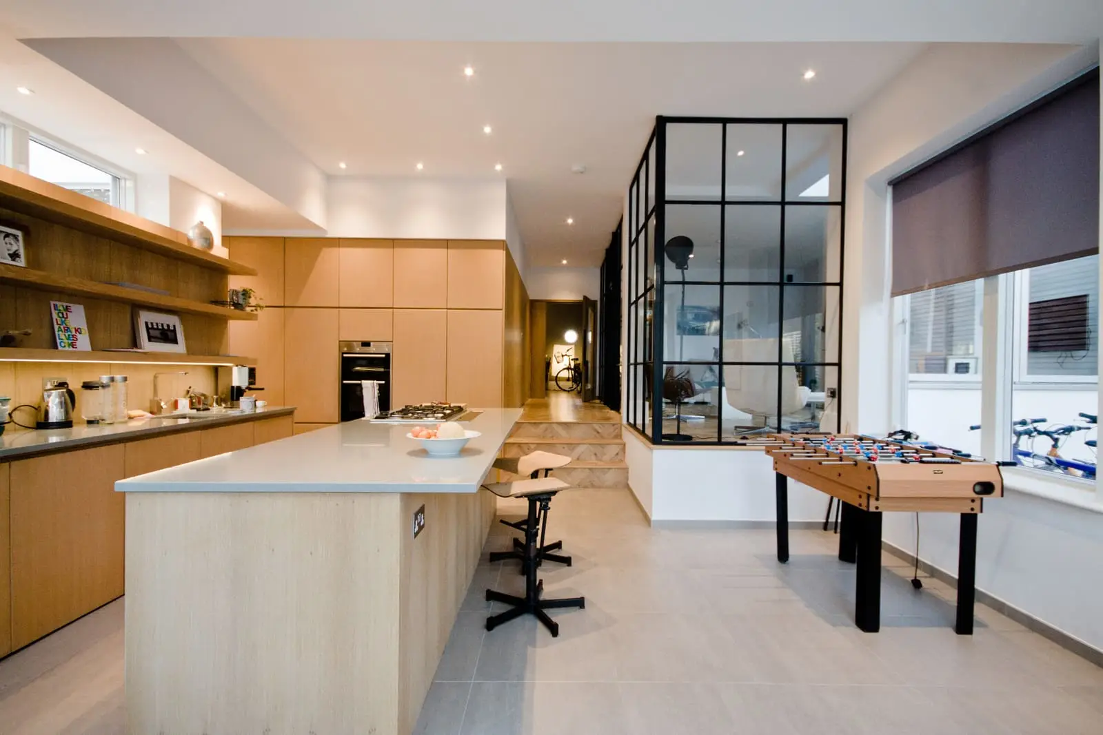 Contemporary open-plan kitchen and living area with industrial design elements